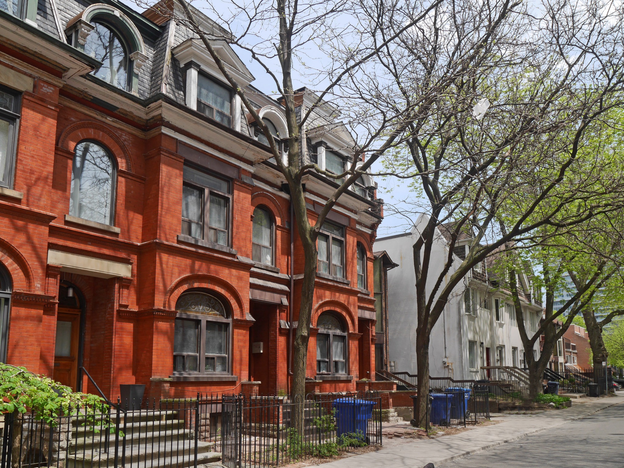 Historic brick buildings on a tree-lined street